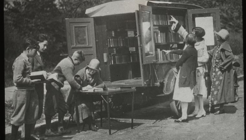 "Readers choosing books and checking them out", ca. 1920s. Manuscripts and Archives Division, The New York Public Library