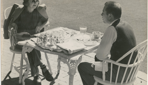 Margaret Sullavan and Leland Hayward outside at table, 1940. Billy Rose Theatre Division, The New York Public Library