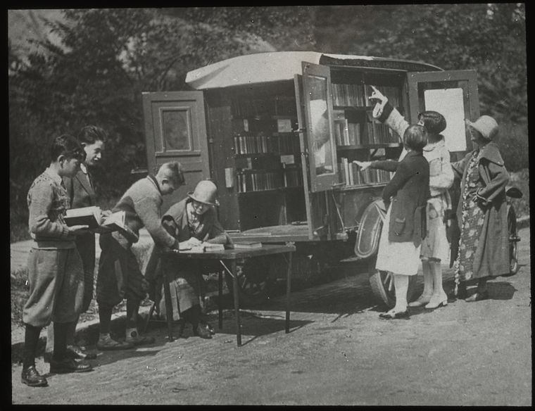 "Readers choosing books and checking them out", ca. 1920s. Manuscripts and Archives Division, The New York Public Library