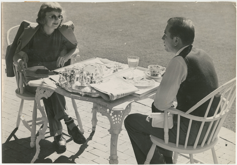 Margaret Sullavan and Leland Hayward outside at table, 1940. Billy Rose Theatre Division, The New York Public Library
